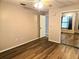 Bedroom with wood floors, mirrored closet, and natural light at 1607 Northlake Dr # 1607, Sanford, FL 32773