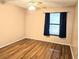 Bedroom featuring wood floors, ceiling fan, and window with curtains at 1607 Northlake Dr # 1607, Sanford, FL 32773