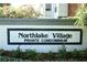 Northlake Village private condominium community sign with manicured landscaping and tasteful building architecture at 1607 Northlake Dr # 1607, Sanford, FL 32773