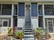 Apartment building exterior with gray staircase, planters, and AC units at 1607 Northlake Dr # 1607, Sanford, FL 32773