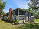 Charming condo building with a brick chimney, screened porches, landscaping, and convenient staircase access at 1607 Northlake Dr # 1607, Sanford, FL 32773