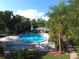 Community pool with a nearby clubhouse and lush tropical landscaping at 1607 Northlake Dr # 1607, Sanford, FL 32773
