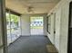 Screened in porch with outdoor carpeting, ceiling fan, and views of the community at 1607 Northlake Dr # 1607, Sanford, FL 32773