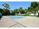 Community tennis court on a sunny day with a view of the green trees at 1607 Northlake Dr # 1607, Sanford, FL 32773