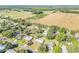 Picturesque aerial view of a residential area surrounded by verdant fields and mature trees, offering a serene setting at 1617 Hontoon Rd, Deland, FL 32720