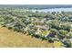 Expansive aerial view showcasing a neighborhood with lush greenery and a shimmering lake in the background at 1617 Hontoon Rd, Deland, FL 32720