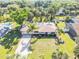Aerial view of a well-maintained single-story home with mature trees, a pool, and a long driveway at 1617 Hontoon Rd, Deland, FL 32720