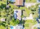 Aerial view of property featuring mature landscaping, palm trees, detached shed and inground pool at 1617 Hontoon Rd, Deland, FL 32720