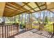 Charming back porch overlooks lush backyard with mature trees and an open patio space at 1617 Hontoon Rd, Deland, FL 32720