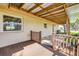 Relaxing back porch with brick flooring, offering views of the serene backyard landscape at 1617 Hontoon Rd, Deland, FL 32720