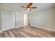 Bedroom with wood floors, ceiling fan, closet, and neutral paint at 1617 Hontoon Rd, Deland, FL 32720