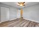 Bedroom with wood-look floors, ceiling fan, and convenient access to other rooms at 1617 Hontoon Rd, Deland, FL 32720