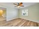 Bedroom featuring wood floors, a ceiling fan, and a window with natural light at 1617 Hontoon Rd, Deland, FL 32720