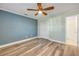Bedroom featuring wood floors, ceiling fan, closet, and neutral paint at 1617 Hontoon Rd, Deland, FL 32720