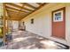 Spacious covered patio featuring a brick floor and wood beam ceiling, great for outdoor entertaining at 1617 Hontoon Rd, Deland, FL 32720