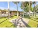 Exterior of a single-Gathering home with mature palm trees, a fire pit and a stone walkway at 1617 Hontoon Rd, Deland, FL 32720