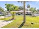 Charming single-story home featuring a well-manicured lawn and mature trees at 1617 Hontoon Rd, Deland, FL 32720