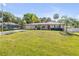 Charming single-story home featuring a well-manicured lawn and a long driveway on a sunny day at 1617 Hontoon Rd, Deland, FL 32720