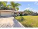 Charming single-story home featuring a well-manicured lawn, mature trees, and an attached garage at 1617 Hontoon Rd, Deland, FL 32720