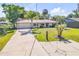 Charming single-story home featuring a lush front yard, long driveway, and attached garage at 1617 Hontoon Rd, Deland, FL 32720