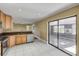 Kitchen with stainless steel appliances, granite countertops, tile flooring, and sliding glass door at 1617 Hontoon Rd, Deland, FL 32720