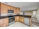 Kitchen with stainless steel appliances, granite countertops, and tile flooring at 1617 Hontoon Rd, Deland, FL 32720