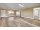 Spacious living room featuring wood floors, a ceiling fan, natural light, and neutral paint at 1617 Hontoon Rd, Deland, FL 32720