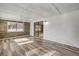 Bright living room boasts wood-look floors, accent wall, and sliding glass doors at 1617 Hontoon Rd, Deland, FL 32720