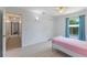 Bright bedroom featuring wood-look floors, closet, and a sunlit window with light blue curtains at 1802 Concert Rd, Deltona, FL 32738