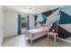 Bright bedroom featuring painted geometric wall design, light wood floors, and natural light at 1802 Concert Rd, Deltona, FL 32738