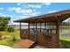 Outdoor gazebo with seating and views of the lake and surrounding greenery at 1802 Concert Rd, Deltona, FL 32738