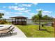 Charming gazebo overlooking the lake, complete with seating and nearby lounge chairs at 1802 Concert Rd, Deltona, FL 32738
