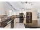 Beautiful kitchen boasts white cabinetry, backsplash tiling, stainless steel appliances and stone countertops at 1802 Concert Rd, Deltona, FL 32738