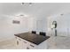 Kitchen island with white cabinets and dark countertops for dining and entertaining in an open space at 1802 Concert Rd, Deltona, FL 32738
