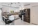 Modern kitchen boasts white cabinetry, a black countertop island and black stainless steel appliances at 1802 Concert Rd, Deltona, FL 32738