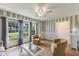 Bright living room featuring striped walls, tile floor, and large windows with a view of the outdoors at 1802 Concert Rd, Deltona, FL 32738