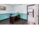 Comfortable home office with a stained wood desk, decorative green paint and hardwood floors at 1802 Concert Rd, Deltona, FL 32738