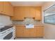 Well-lit kitchen with bright yellow cabinetry, a white farmhouse sink, and a tiled backsplash at 1821 Goodrich Ave, Winter Park, FL 32789
