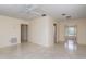 Spacious living room with tiled flooring, a ceiling fan, and natural light streaming through the doorway at 1821 Goodrich Ave, Winter Park, FL 32789