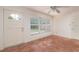Cozy sunroom with tiled floor, lots of natural light, and access to the outdoors through a glass-paneled door at 1821 Goodrich Ave, Winter Park, FL 32789