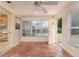 Bright sunroom featuring tiled flooring, large windows, a ceiling fan, and direct access to the backyard at 1821 Goodrich Ave, Winter Park, FL 32789