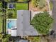 Aerial view of house showing manicured backyard with a pool, mini putting green and landscaping at 2004 Mohawk Trl, Maitland, FL 32751