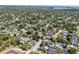 An expansive aerial view shows a neighborhood with tree-lined streets and well-maintained homes at 2004 Mohawk Trl, Maitland, FL 32751
