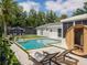 Charming backyard featuring a pool, sauna, lounge chairs, and a manicured lawn at 2004 Mohawk Trl, Maitland, FL 32751