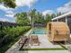 Inviting backyard featuring a pool, sauna, lounge chairs, and a gazebo with an outdoor dining set at 2004 Mohawk Trl, Maitland, FL 32751