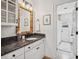 Bathroom featuring granite counters, stylish mirror, and views into the walk in shower at 2004 Mohawk Trl, Maitland, FL 32751