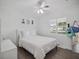 Bright bedroom features hardwood floors, a ceiling fan, and a window with natural light at 2004 Mohawk Trl, Maitland, FL 32751