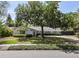 Charming single-story home featuring a lush front yard, mature trees, and a covered entrance at 2004 Mohawk Trl, Maitland, FL 32751