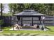Outdoor gazebo featuring comfortable seating, a small table, and manicured landscaping at 2004 Mohawk Trl, Maitland, FL 32751
