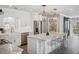 Bright, modern kitchen with white cabinetry, stainless steel appliances, and a stylish marble island at 2004 Mohawk Trl, Maitland, FL 32751